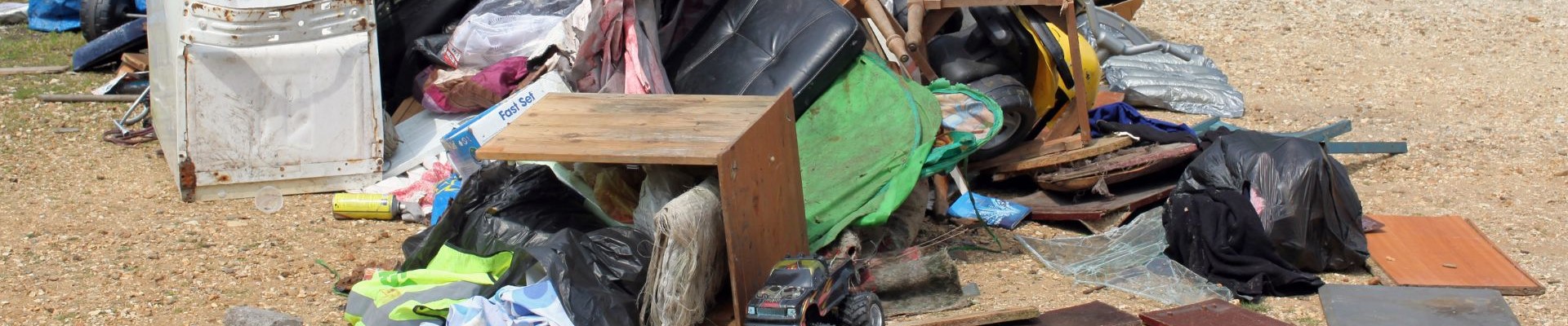 Fly-tipped pile of rubbish and household items