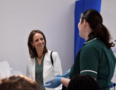 Minister Helen Whately talking to student
