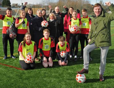 Cllr Tony Higgins stands with council members, staff and Cardinal Newman students on the new 3G pitch.