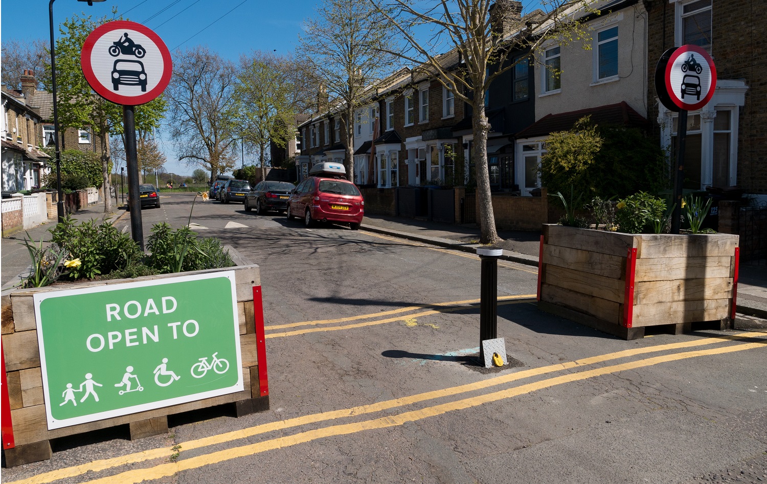 An example of a low traffic neighbourhood with traffic bollards and signage supporting cycle through routes