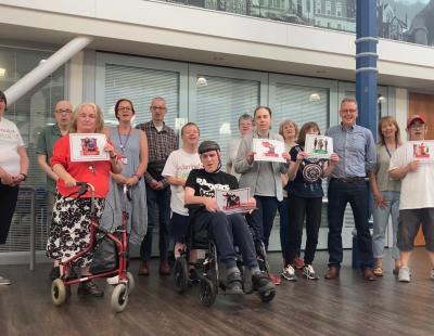 Members of Warrington Speak Up pose with their human rights cards designs