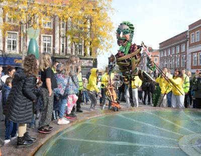 Image of the Out of the Deep Blue Festival, with Eko the giant street puppet walking through Warrington town centre.