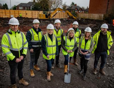 Image of a group of officers from Livv Housing Group, PGS and Warrington Borough Council, with a shovel, breaking ground at the site of a new housing development.