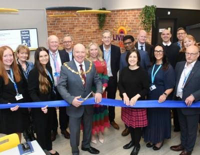 A group photo including representatives of the council, hospital, VCSE, Merseycare and Bridgewater, to mark the opening of the Living Well Hub